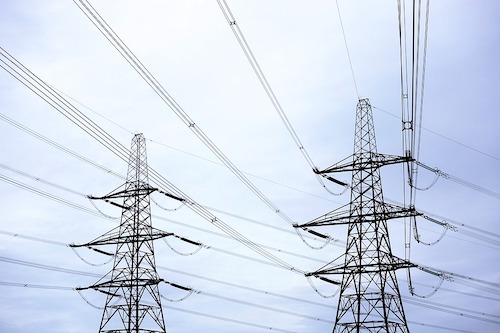 Power-lines and pylons against a blue sky