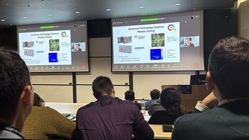 QCS Project Forum image - people sat in lecture theatre