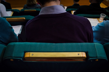 Close-up image of man sat in the Mary Ogilvie Lecture Theatre